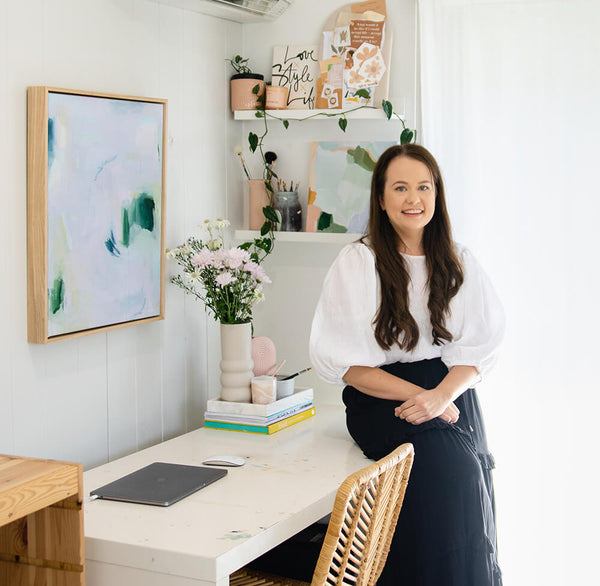 Image of Australian Artist and Writer Kellie Leader in her Greater Brisbane Studio surrounded by flowers and contemporary artworks