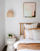 Modern pastel Australian abstract art hangs in coastal boho style bedroom with neutral and white decor