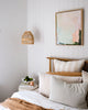 Modern peach and green abstract artwork hangs in relaxed luxe style Australian coastal bedroom